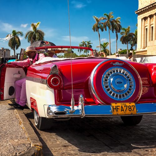 HAVANA-AUGUST 14:Classic Ford waiting for tourists near the Capitol August 14,2012 in Havana.These old cars are an attraction for the more than 2 million people who come to the island every year