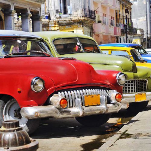 Detail of colorful group of vintage american cars parked in a street of Old havana